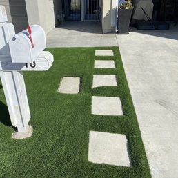 Stepstones with artificial turf ribbons and concrete side yard access.