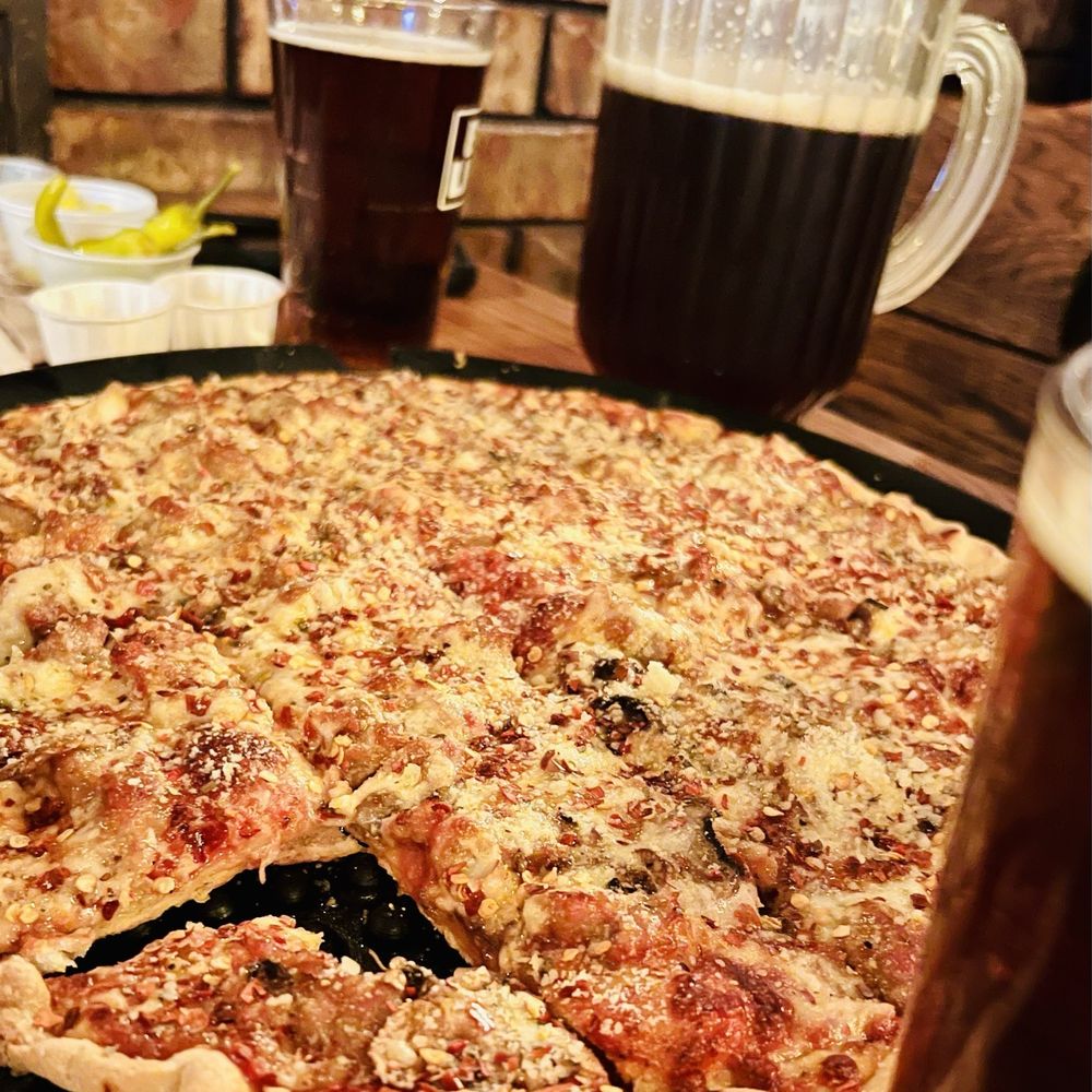 Sausage and mushroom pizza with copious amounts of fresh red pepper, and Parmesan Sausage and mushroom pizza with copious amounts of fresh red pepper, and Parmesan