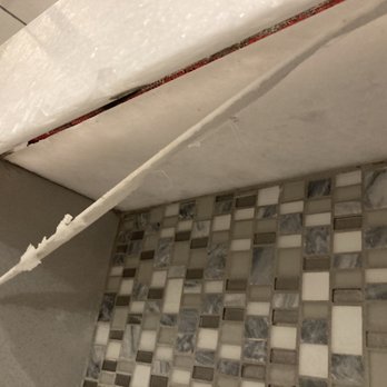 Papagno's Marble and Granite - Held in place by this flimsy piece of "glue" at top and bottom. - General Contractors Near Me - Scottsdale, Arizona
