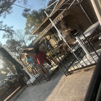 Pee Wee's Snack Shack - a man and a woman eating outside - Burgers Near Me - Houston, Texas
