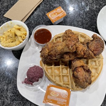 Dame's Chicken & Waffles - Light Brown Leghorns with blueberry smear, calypso sauce, and mac & cheese side (bite or two taken out). - Southern Near Me - Durham, North Carolina
