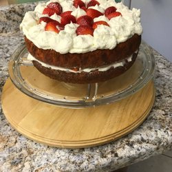 Strawberry jello cake with fresh whipped cream and fresh strawberries.