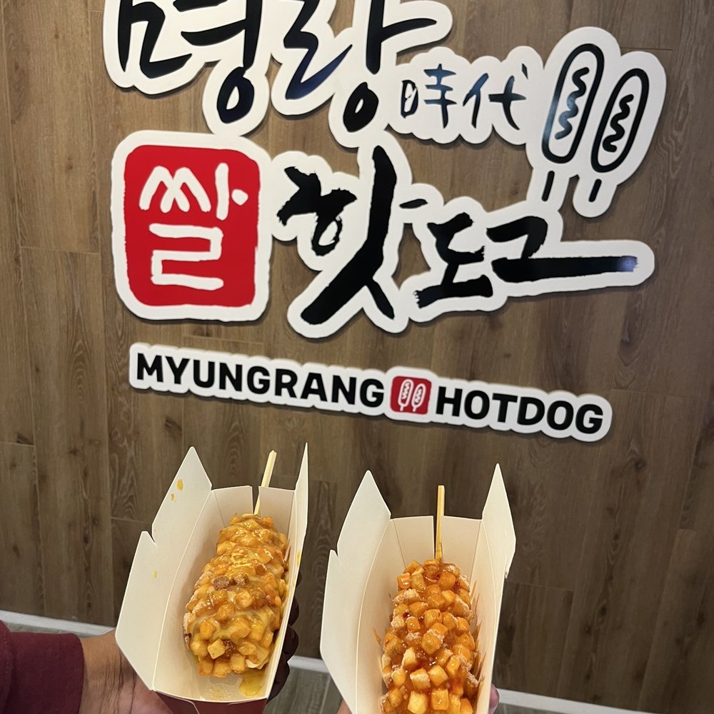 Myungrang Hot Dog - a man holding two hotdogs - Hot Dogs Near Me - Toronto, Ontario Myungrang Hot Dog - a man holding two hotdogs - Hot Dogs Near Me - Toronto, Ontario