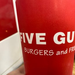 a red cup with the words five guys burgers and fries on it a red cup with the words five guys burgers and fries on it