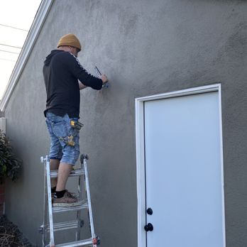 Mario Handyman Service - Mario working on installing a new exterior lamp. - Handyman Near Me Mario Handyman Service - Mario working on installing a new exterior lamp. - Handyman Near Me