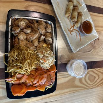 The Hibachi Pit - Spring rolls, Hibachi Chicken half/half noodles and fried rice with carrots on the grill. - Japanese Near Me - Concord, North Carolina The Hibachi Pit - Spring rolls, Hibachi Chicken half/half noodles and fried rice with carrots on the grill. - Japanese Near Me - Concord, North Carolina