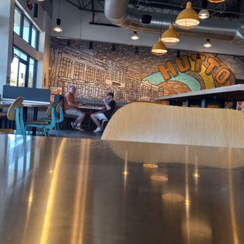 MOD Pizza - two people sitting at a table in a restaurant - Pizza Near Me - Hutto, Texas MOD Pizza - two people sitting at a table in a restaurant - Pizza Near Me - Hutto, Texas