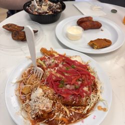 Catrachos Restaurant - Yuca con chicharrón, Tajadas, arroz con Carne asada, salchichas and a Pastelito
