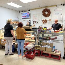 Dariusz Polish Deli and Grocery - Deli counter and register. Menu on back wall.