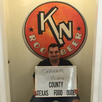 K & N Root Beer & Ice Cream Parlor - a man holding a sign - New American Near Me - Graham, Texas K & N Root Beer & Ice Cream Parlor - a man holding a sign - New American Near Me - Graham, Texas