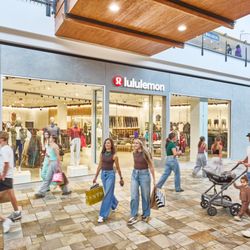 FlatIron Crossing - Shoppers passing the lululemon storefront inside FlatIron Crossing.