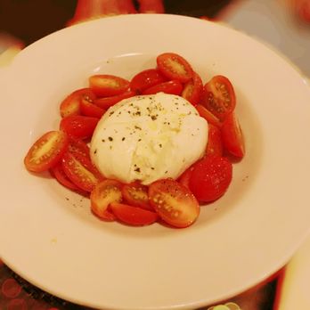 Oltre Mare - a plate of tomatoes and an egg - Italian Near Me - San Diego, California Oltre Mare - a plate of tomatoes and an egg - Italian Near Me - San Diego, California