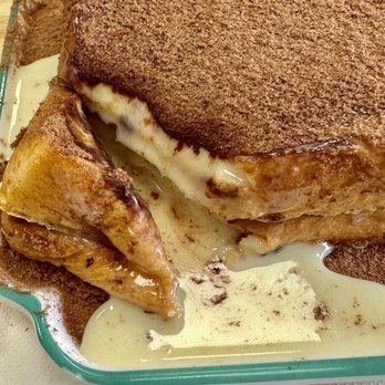 HK Cafe - The reduced condensed milk, poured on top and covered w Ovaltine powder oozes like lava when cut. - Hong Kong Style Cafe Near Me - Honolulu, Hawaii