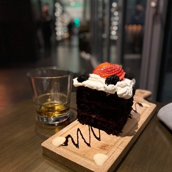 Whiskey Charlie - a slice of chocolate cake with whipped cream and strawberries - Cocktail Bars Near Me - Washington, DC, District of Columbia Whiskey Charlie - a slice of chocolate cake with whipped cream and strawberries - Cocktail Bars Near Me - Washington, DC, District of Columbia