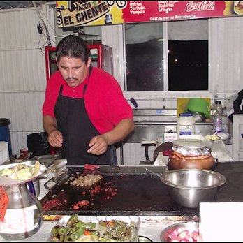 Tacos El Chente - The other gentleman - I didn't get his name - is making tacos for another customer.  It's almost midnight, and Tacos El Chente is busy... - Seafood Near Me - Ensenada, BCN
