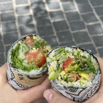 Rolltation - a hand holding a wrap of food - Sushi Bars Near Me - Toronto, Ontario