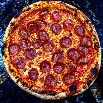 Wolf Pizza - a pepperoni pizza on a table - Pizza Near Me - Falmouth, Massachusetts