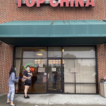 Top China - two people standing outside of a store - Chinese Near Me - Cape Charles, Virginia