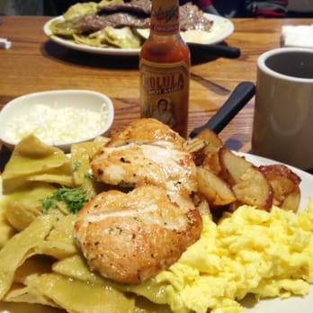 Tiztal Cafe - Chicken chilaquiles with scrambled eggs. Steak chilaquiles in the background - Breakfast & Brunch Near Me - Chicago, Illinois Tiztal Cafe - Chicken chilaquiles with scrambled eggs. Steak chilaquiles in the background - Breakfast & Brunch Near Me - Chicago, Illinois