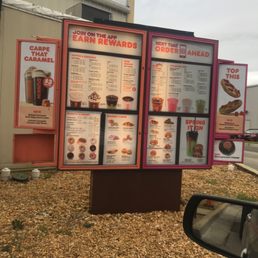 a menu and a drink on a stand a menu and a drink on a stand