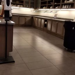 Empty breakfast area . Normally , juice, fruit ,oatmeal yogurt, hard boiled eggs, muffins , bagels , pancakes , and occasionally bacon!