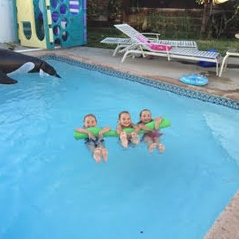 Murdock Pool Service - Some kids enjoying a float in a pool cleaned my Murdock Pool Service. - Pool Cleaners Near Me Murdock Pool Service - Some kids enjoying a float in a pool cleaned my Murdock Pool Service. - Pool Cleaners Near Me
