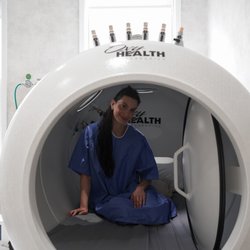 IV Elements - A client seated inside the OxyHealth hyperbaric chamber, ready for a hyperbaric oxygen therapy session.