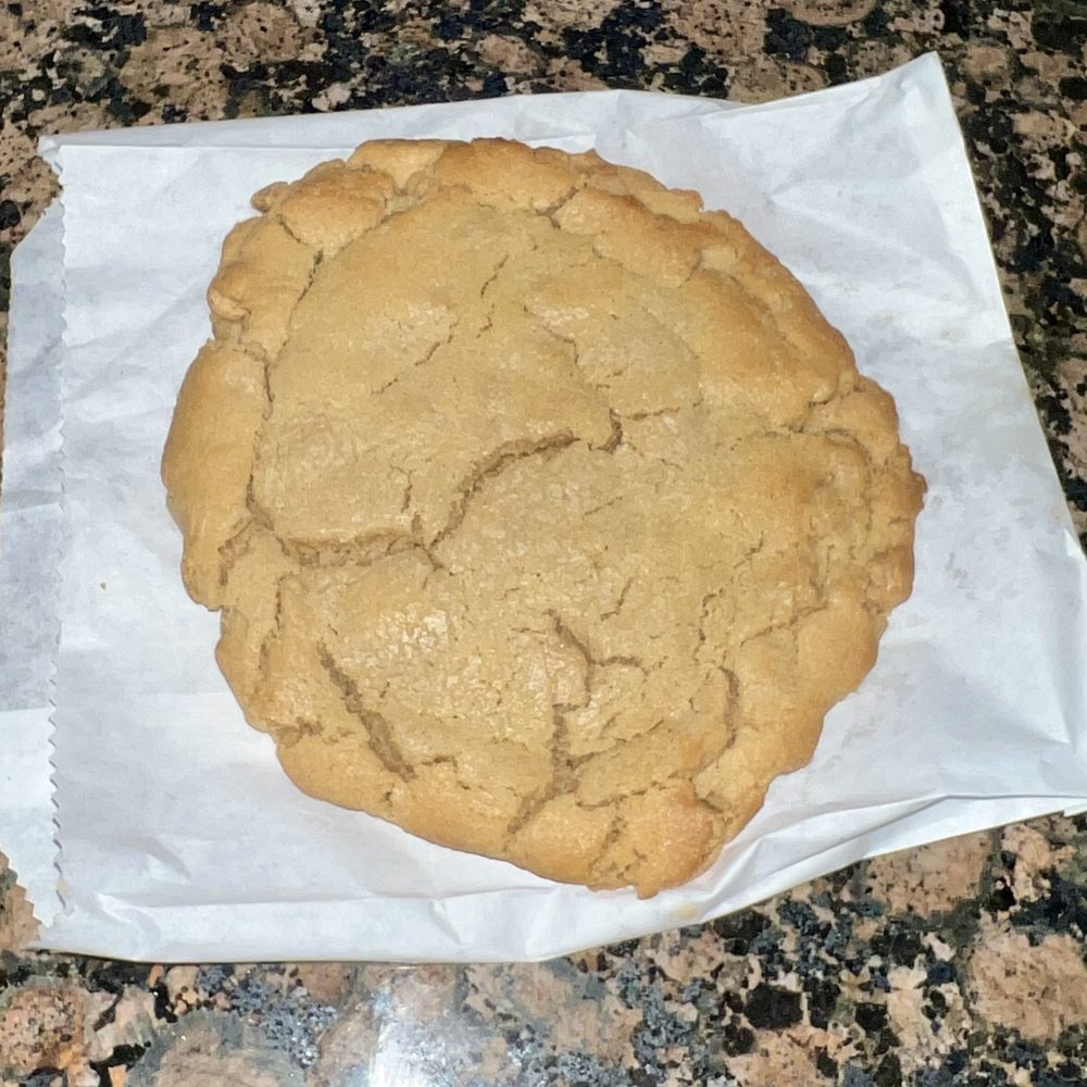 Suga's Cakery - Yes-it might be the worlds largest peanut butter cookie. My husband already has the chocolate chip one in his possession.!!!! - Bakeries Near Me - Pflugerville, Texas