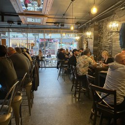 people sitting at tables in a restaurant