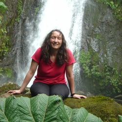 Vital Writer Services - Chief Editor and Bottle Washer Elizabeth (Betsy) Herman with friends, leaf, rock and waterfall in Costa Rica.