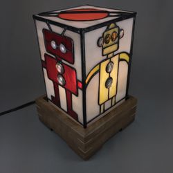 Jancik Glass - This is a whimsical stained glass robot lamp. There are four different robots on the lamp. The perfect gift for the geek in your life.