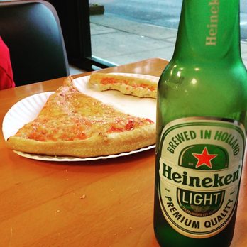 Joe's Pizza - a bottle of heineken beer and a slice of pizza - Pizza Near Me - Copiague, New York