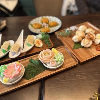 Sarisa Cafe - a variety of appetizers on wooden trays - Desserts Near Me - New York, New York Sarisa Cafe - a variety of appetizers on wooden trays - Desserts Near Me - New York, New York