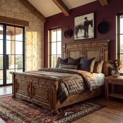 Adobe Interiors - Western bedroom styling with a carved wood bed, layered textiles, and bison artwork.