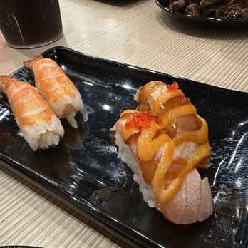 Tenko Sushi - two pieces of sushi on a black plate - Sushi Bars Near Me - Windsor, Ontario Tenko Sushi - two pieces of sushi on a black plate - Sushi Bars Near Me - Windsor, Ontario