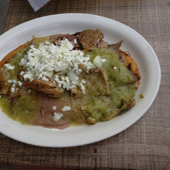 Taco Libre - Huarache with beans, carnitas (fried pork), queso blanco (white cheese) and salsa verde (green sauce) all on top of a crispy corn patty - Tacos Near Me - Jacksonville, Florida Taco Libre - Huarache with beans, carnitas (fried pork), queso blanco (white cheese) and salsa verde (green sauce) all on top of a crispy corn patty - Tacos Near Me - Jacksonville, Florida