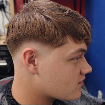 Barber Shop - Mid fade with textured top  Clean blend, smooth transition, and modern styled finish. Professional cut by Lugo Boss. - Barbers Near Me - Buffalo, New York