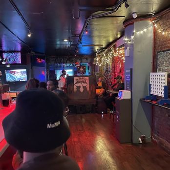 Karma Sutra - people sitting at a bar watching tvs - Bars Near Me - New York, New York