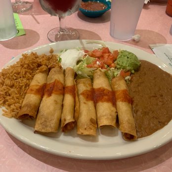 Chuy's - Rice, beans and I believe those are the taquitos filled with chicken and cheese. - Bars Near Me - Pembroke Pines, Florida