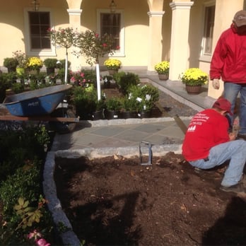 A Vulpone Landscaping - two men working in a garden - Landscaping Near Me