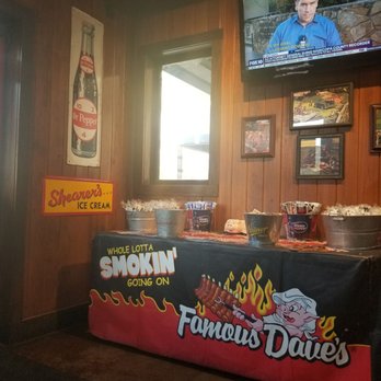 Famous Dave's Bar-B-Que - Table with sauces which makes it nice to be able to grab what you need, since some of us, want to drown our food in sauce. - Barbeque Near Me - Chandler, Arizona Famous Dave's Bar-B-Que - Table with sauces which makes it nice to be able to grab what you need, since some of us, want to drown our food in sauce. - Barbeque Near Me - Chandler, Arizona