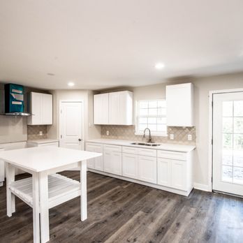 Ark Depot - a kitchen with white cabinets and wood floors - Flooring Near Me - Dallas, Texas