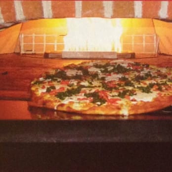 Napoli Pizza - a pizza cooking in a brick oven - Pizza Near Me - Henrico, Virginia Napoli Pizza - a pizza cooking in a brick oven - Pizza Near Me - Henrico, Virginia