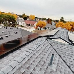 a view of a rooftop with solar panels a view of a rooftop with solar panels