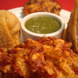 Lal Mirch Indian Restaurant - Sampler Platter, comes with vege pakora, onion bhaji, two somosas, complimented with two house condiments