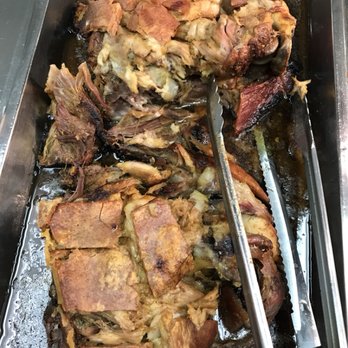 Chris Super Deli - a roast of meat in a pan with tongs - Delis Near Me - Bronx, New York Chris Super Deli - a roast of meat in a pan with tongs - Delis Near Me - Bronx, New York