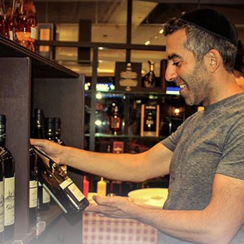 Revaya Wine and Liquor - a man opening a bottle of wine - Beer, Wine & Spirits Near Me - Brooklyn, New York Revaya Wine and Liquor - a man opening a bottle of wine - Beer, Wine & Spirits Near Me - Brooklyn, New York