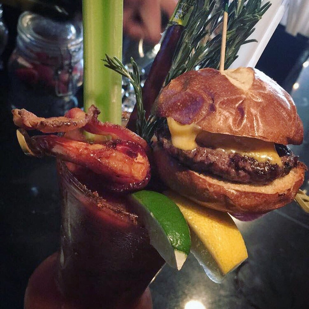 The Villager - Bloody w/ bacon salt rim, bacon slice, bacon wrapped shrimp, slim jim, celery, rosemary, lemon, lime, & cheese slider - New American Near Me - Babylon, New York