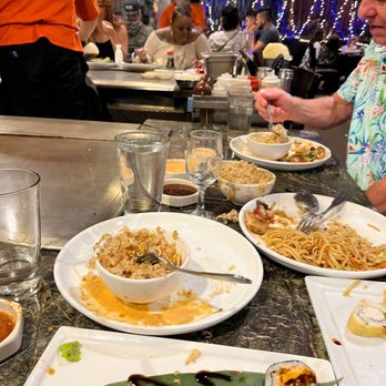 Shogun Restaurant - a man sitting at a table with plates of food - Japanese Near Me - Corona, California Shogun Restaurant - a man sitting at a table with plates of food - Japanese Near Me - Corona, California