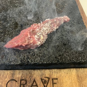 Crave Kitchen & Bar - Wagu dipped in salt and cooking - Bars Near Me - Eagle, Idaho